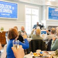 Event guests raising a glass with speaker at podium